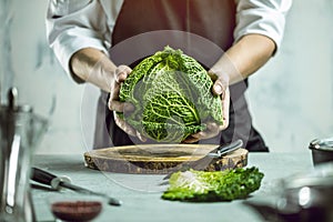 Chef prepares vegetables to cook in the restaurant kitchen