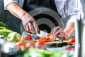 Chef prepares vegetables to cook in the restaurant kitchen