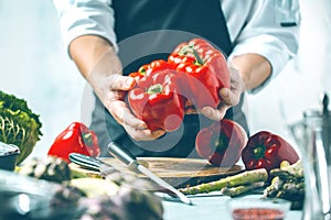 Chef prepares vegetables to cook in the restaurant kitchen