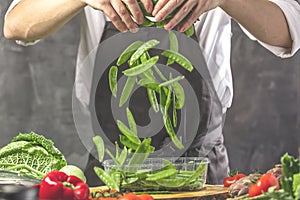 Chef prepares vegetables to cook in the restaurant kitchen