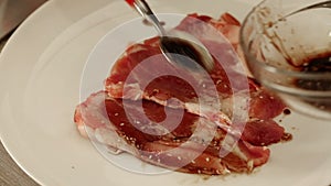 Chef preparing beef steak with soy sauce marinade