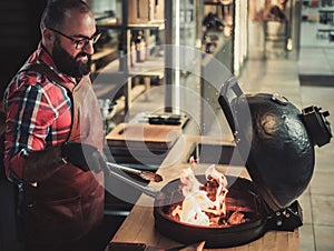 Chef preparing charcoals before grilling in a restaurant