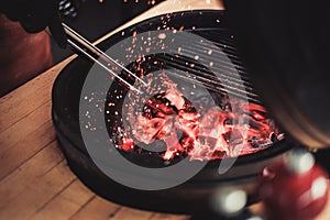 Chef preparing charcoals before grilling in a restaurant photo