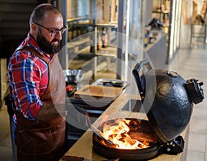 Chef preparing charcoals before grilling in a restaurant