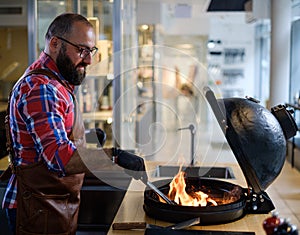 Chef preparing charcoals before grilling in a restaurant