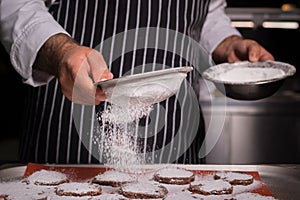 Chef preparing cookies in his kitchen.