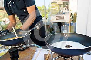 Chef preparing delicious organic pasta dish outdoor. Eating