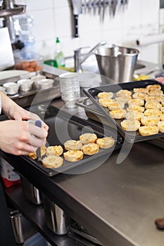 Chef preparing desserts removing them from moulds