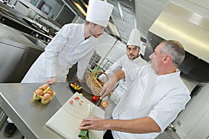 Chef preparing food in kitchen at restaurant