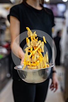 chef preparing french fries in restaurant kitchen