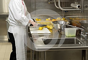 Chef preparing fruit in commercial kitchen