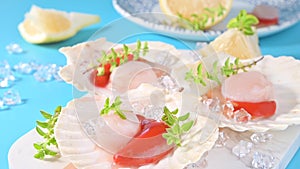 Chef preparing healthy gourmet food, seared scallops with caviar on on a beautiful dish in shellfish shells. A