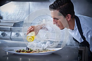 Chef preparing octopus in kitchen with smoke