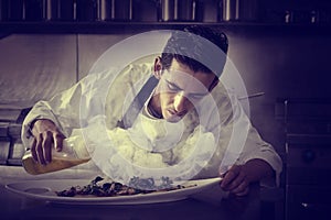 Chef preparing octopus in kitchen with smoke