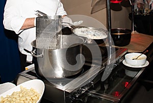 Chef preparing pasta during brunch buffet or food bloggers
