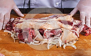 Chef preparing raw lamb chops for cooking separating the rack of lamb