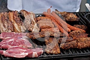 Chef preparing some mititei, sausages and meat