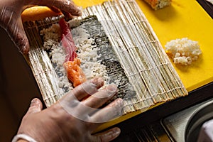 Chef preparing sushi rolls