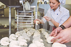 Chef preparing sweet croissant in the pastry shop laboratory
