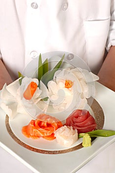 Chef presenting plate of decrative sashimi