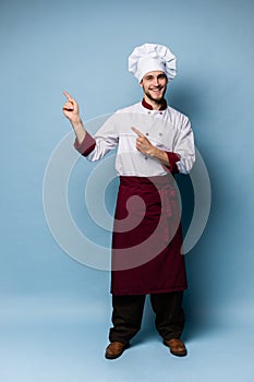 Chef presenting something over light blue background