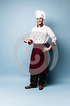 Chef presenting something over light blue background