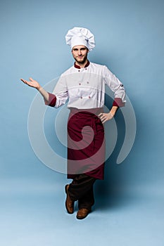 Chef presenting something over light blue background