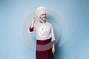 Chef presenting something over light blue background