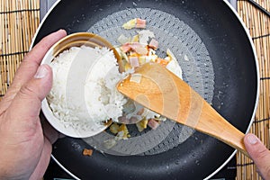 Chef put cooking rice to pan