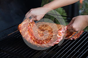 Chef put pork ribs in oven, prepare smoke and cook a smoked barbecue pork ribs