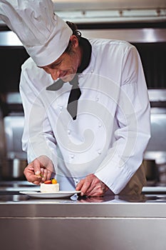 Chef putting finishing touch on dessert