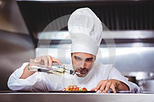 Chef putting finishing touch on salad