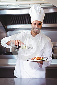 Chef putting finishing touch on salad