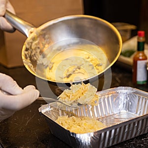 Chef putting fried onion to the box photo