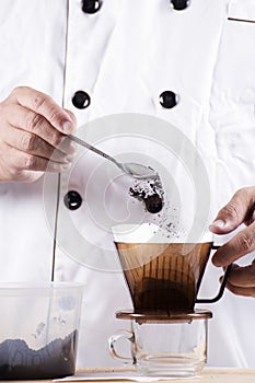 Chef putting grind coffee