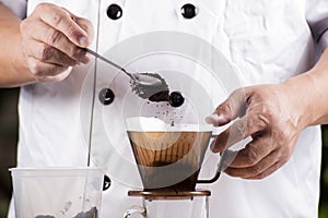 Chef putting grind coffee