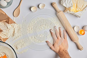 Chef putting hand on table with flour