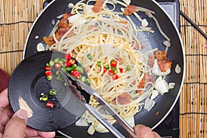 Chef putting slice of chili for cooking