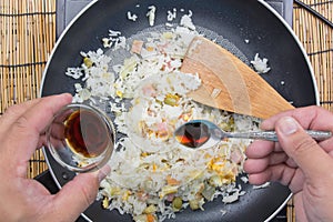 Chef putting soy sauce for cooking fried rice