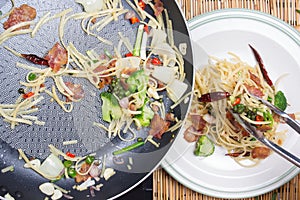 Chef putting spicy spaghetti to plate