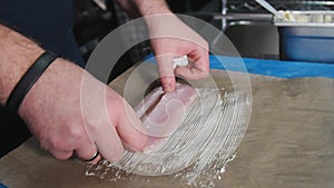 Chef putting white fish fillet on butter on Parchment Paper to bake