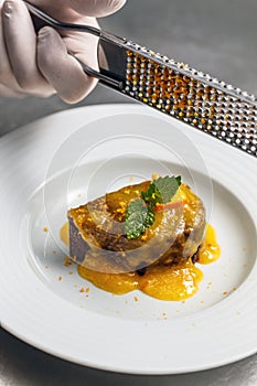 Chef rasping orange zest