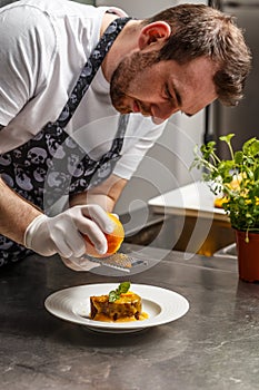 Chef rasping orange zest