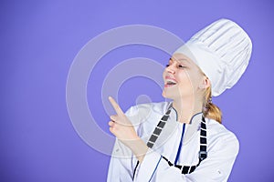 Chef recommend to try something. Confident girl happy chef pointing at copy space. My secret tips culinary. Cooking easy