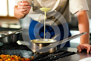 Chef in a restaurant or hotel kitchen cooking