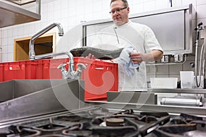 Chef in restaurant kitchen checking fresh fish delivery