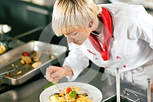 Chef in restaurant kitchen cooking