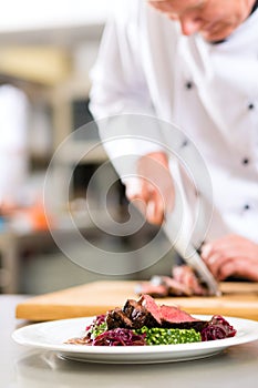 Chef in restaurant kitchen preparing food