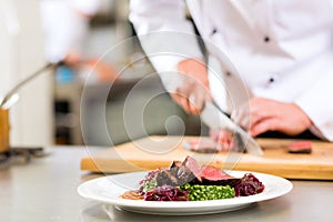 Chef in restaurant kitchen preparing food