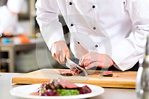 Chef in restaurant kitchen preparing food